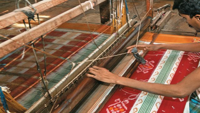 An artisan in the process of creating a Pochampally sari