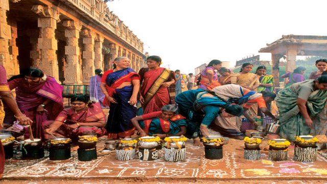 Women cook sweet pongal, a traditional preparation in Tamil Nadu