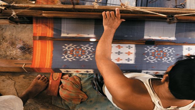 A weaver at a loom making a Pochampally sari