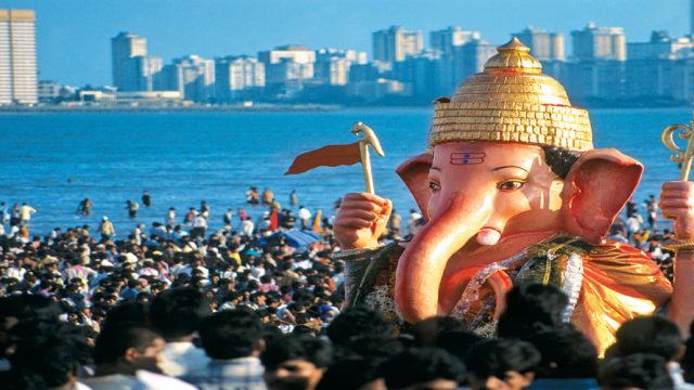 A massive idol of Lord Ganesha being taken down to the sea