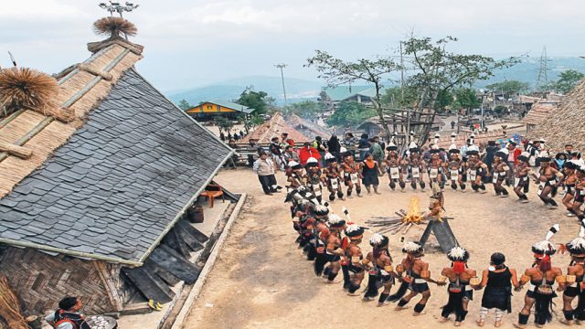 Tribesmen and women perform a traditional dance