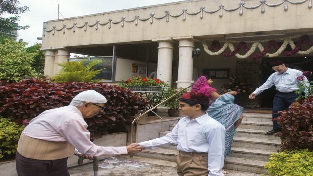 Parsis wish each other outside an agiari on the day of Navroz