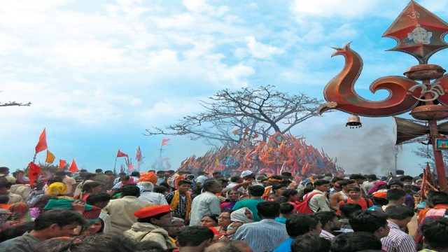 Pilgrims paying obeisance to the stacked trishuls atop Chauragarh mountain