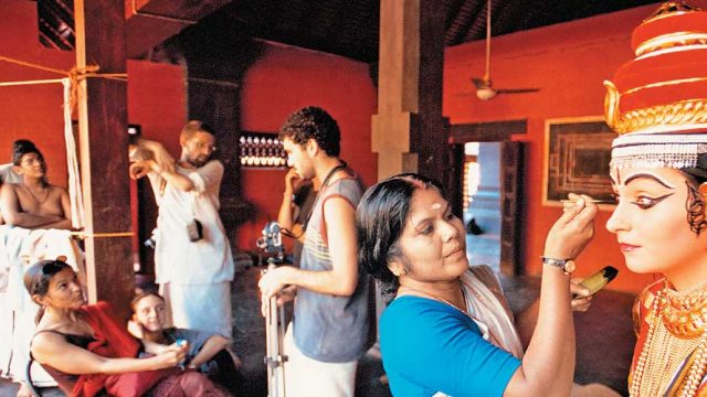 A dancer getting her make-up done at Kalamandalam