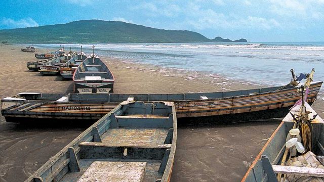 Boats along the shore of Kondivli Beach