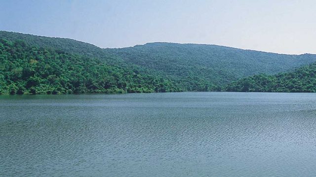 The serene waters of the lake behind Asvali Dam