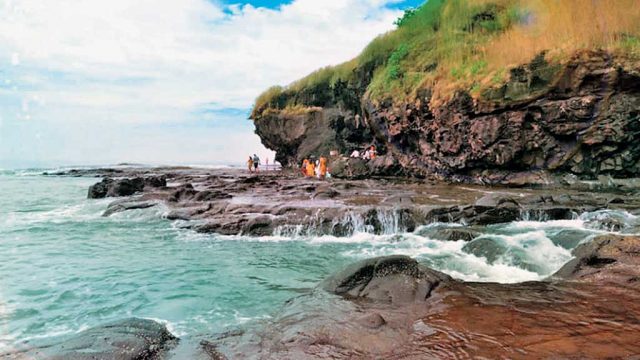 Visitors at the rocky Harihareshwar Beach