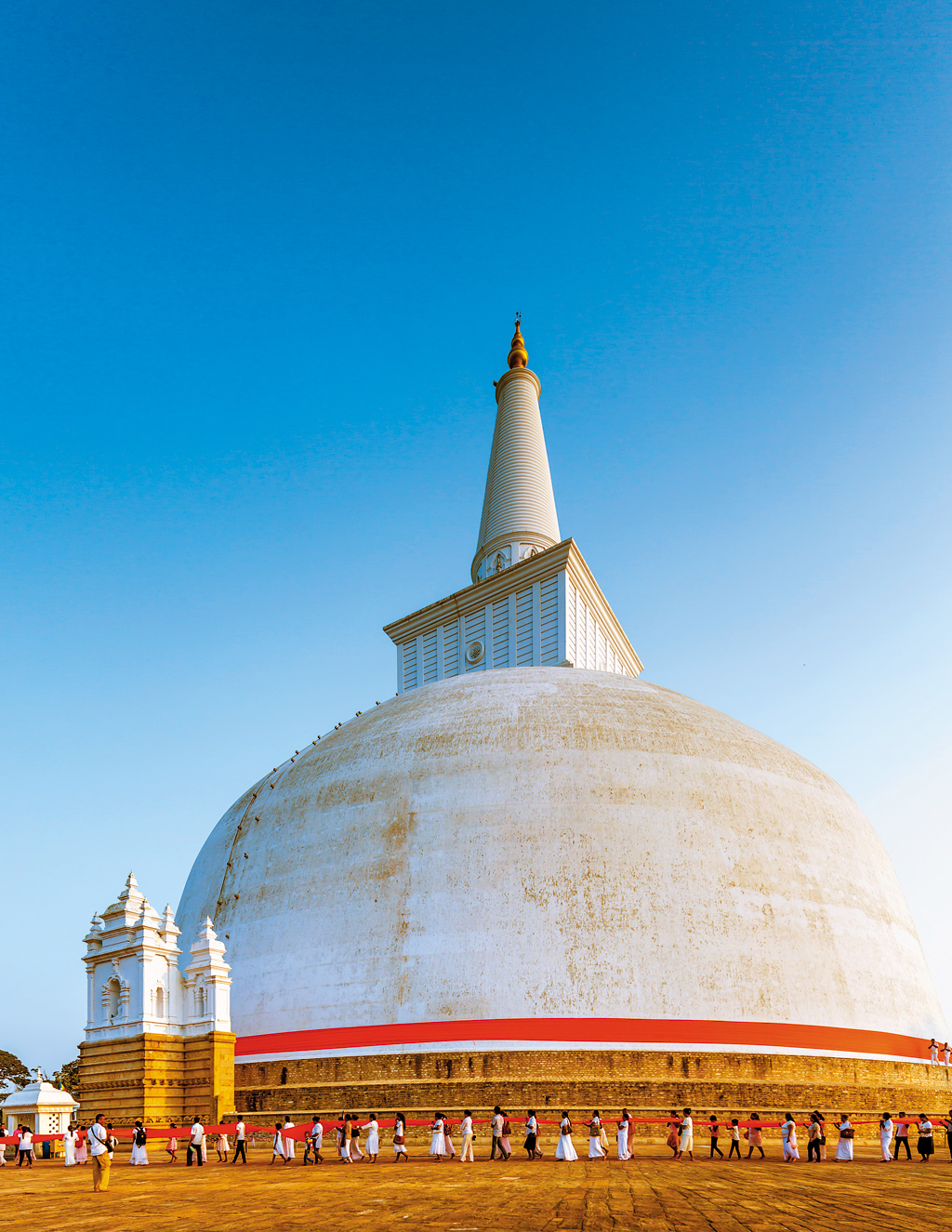 The Ruwanwelisaya Stupa in Anuradhapura, Sri Lanka. The largest stupa in Sri Lanka’s first capital (4th to 11th century CE) is draped in 1,100 feet of saffron cloth 3-4 times a day. Buddha’s relics are believed to be inside the stupa.