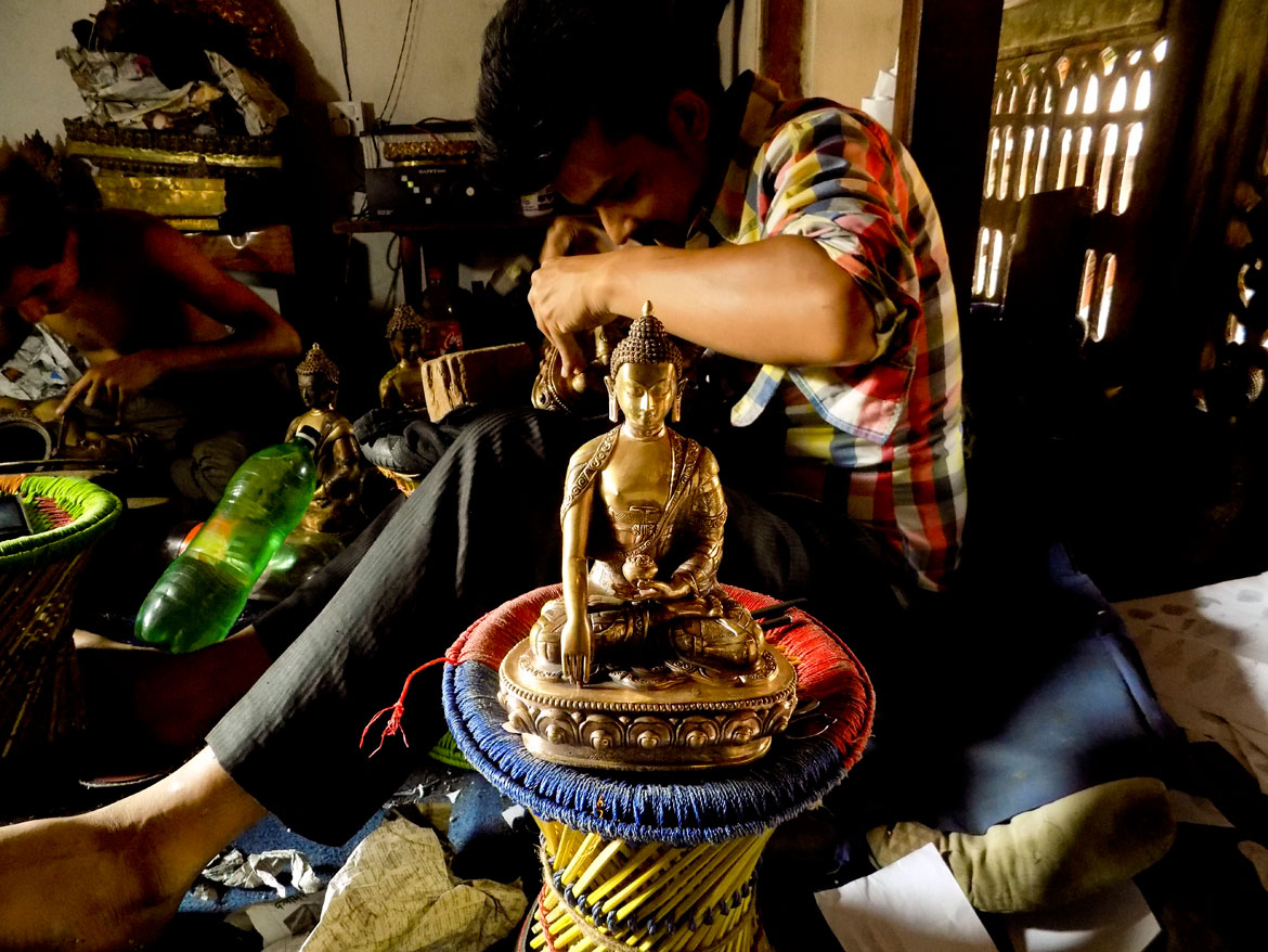 An ever-present sound in the courtyard is the tinkering and hammering produced by artisan guilds, like this one at the Guji Baha. Newar craftsmen work in these small ateliers to produce beautiful statues that are then sold all over the world. One of the most famous historical Newari figures is the legendary sculptor Araniko. He became Kublai Khan's court artist and provided a vital link between the art traditions of India and China.