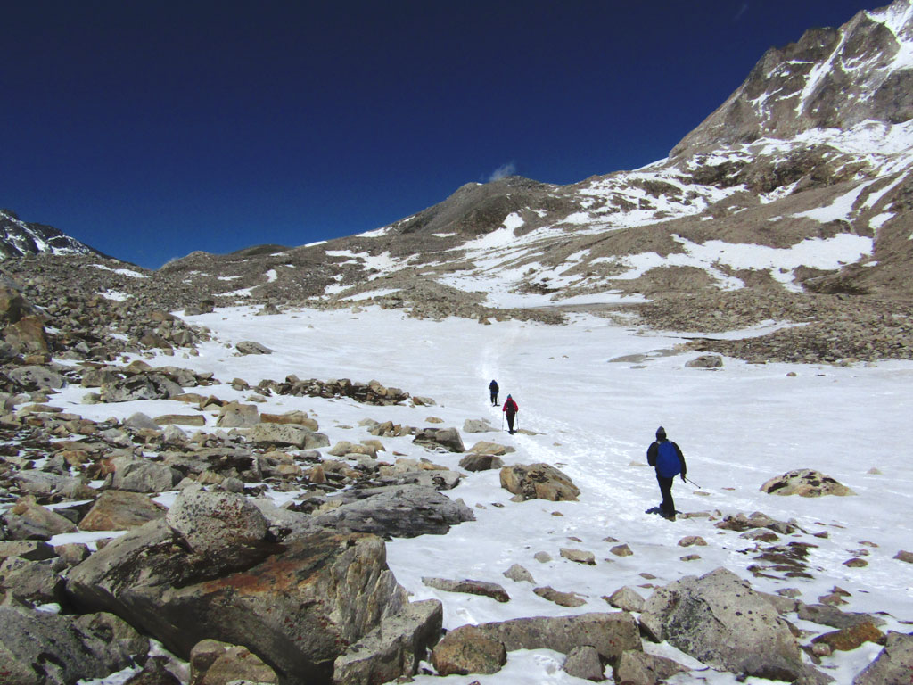 Trekkers crossing a snow-field on their way to the pass