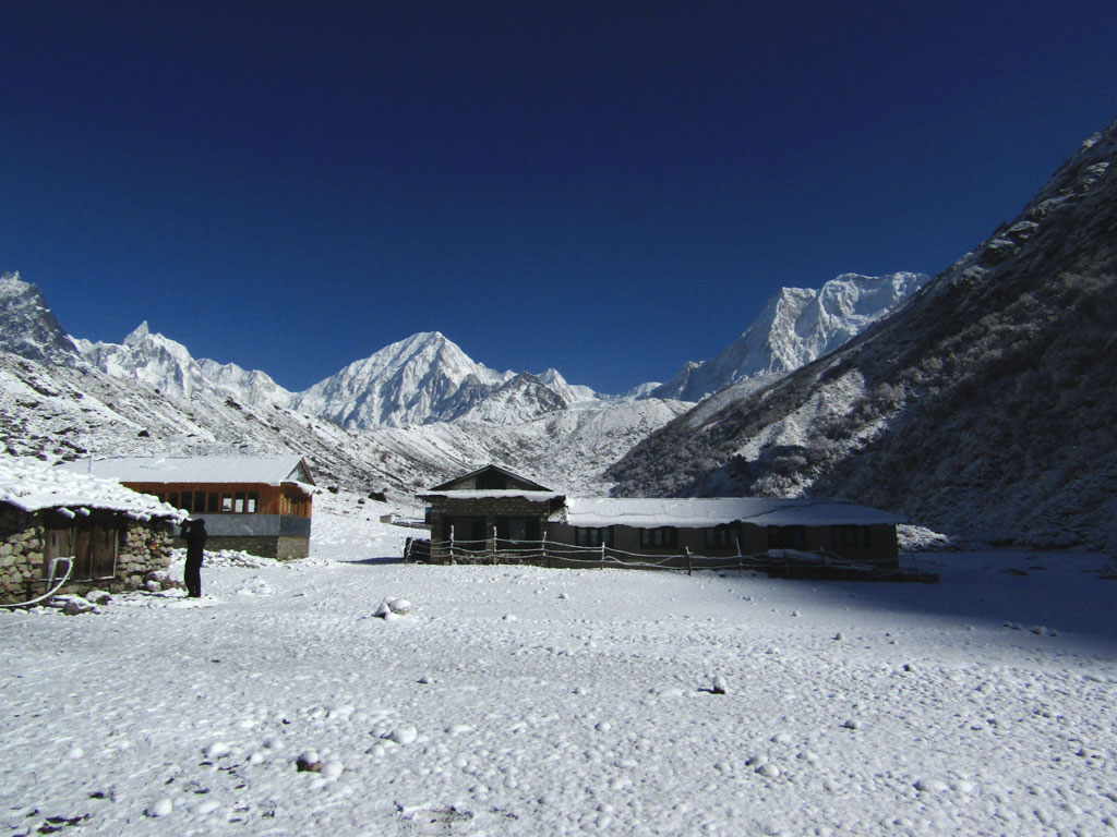 The view from the snowed-in Bimthang village looking north. To the right are the sheer walls of Cheo Himal and in the centre, the peak of Himlung, 7,126m high