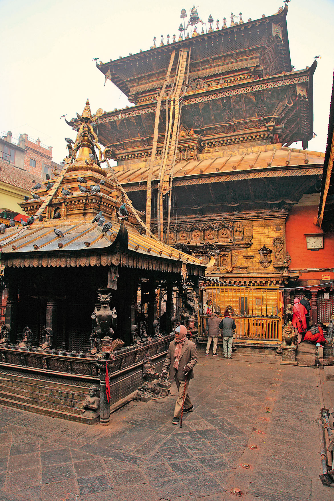 Kwa Baha has Patan's largest sangha or Buddhist community attached to it. As a result, it is also the wealthiest vihara in Patan. It gets its golden sheen from donations over the centuries, with many Hindus too acting as doners to obtain merit. The vihar traces its antecedents to the 12th century, when it was built in the neighbourhood of Nag Bahal near the Durbar Square. In the picture is the sacred Swayambhu Chaitya which also houses many invaluable works of sacred art, quite predictably, made of gold. Behind it is the huge shrine to the main deity of the monastery, the Kwapah Dyah or Sakyamuni Buddha. This is the main exoteric deity of the vihara, open to all who come here. The secret tantric shrine, which can only be visited by the tantric Buddhist priests, the Vajracharyas, is located on an upper floor. All viharas are in the form of a three-dimensional mandala