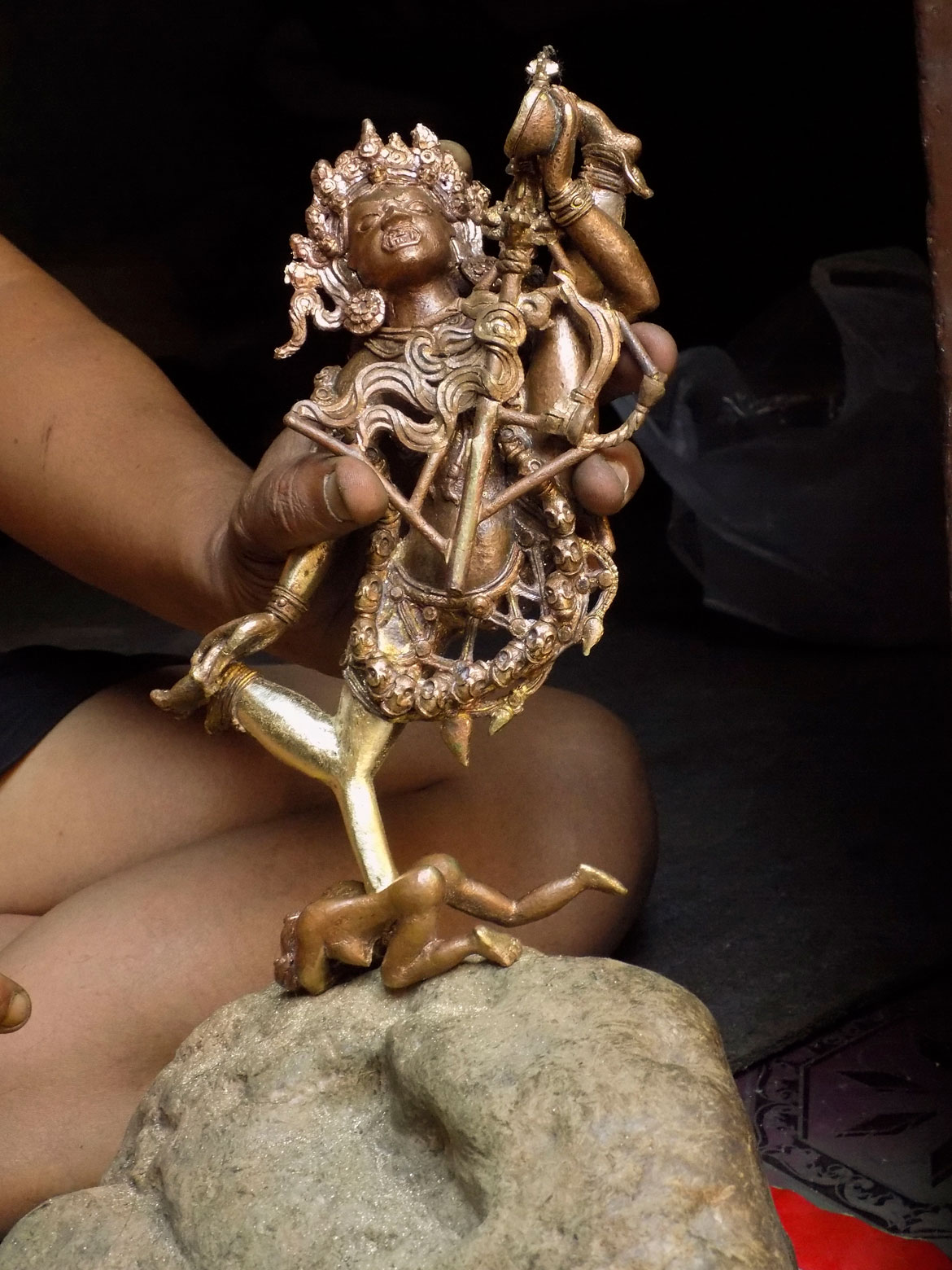 A sculptor works on his unfinished statue of the tantric Buddhist goddess Vajrayogini at a small atelier in the courtyard of Nagu Baha, or Rupbarna Mahavihar