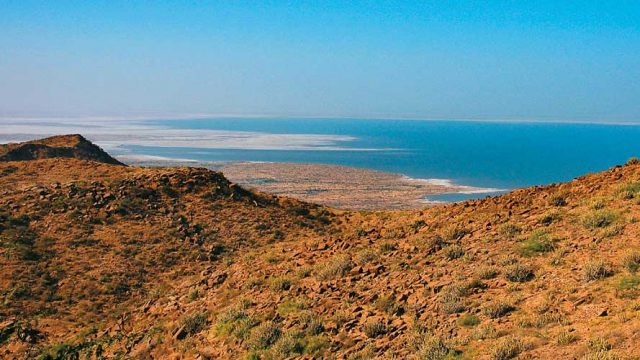 The barren landscape of the Little Rann Of Kutch meeting the sea