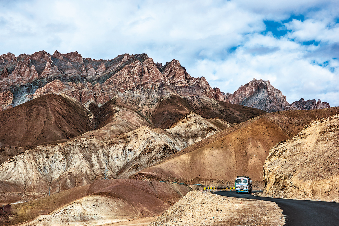 A truck seems to be the only living entity amid the barren hills near Fotu La