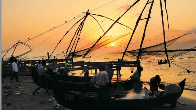 Fishermen hauling in their large Chinese fishing nets at Kochi