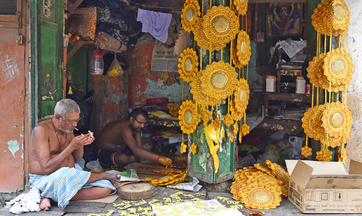 Sellers who keep Durga Puja decorations in Kumartuli take a small break before work starts again