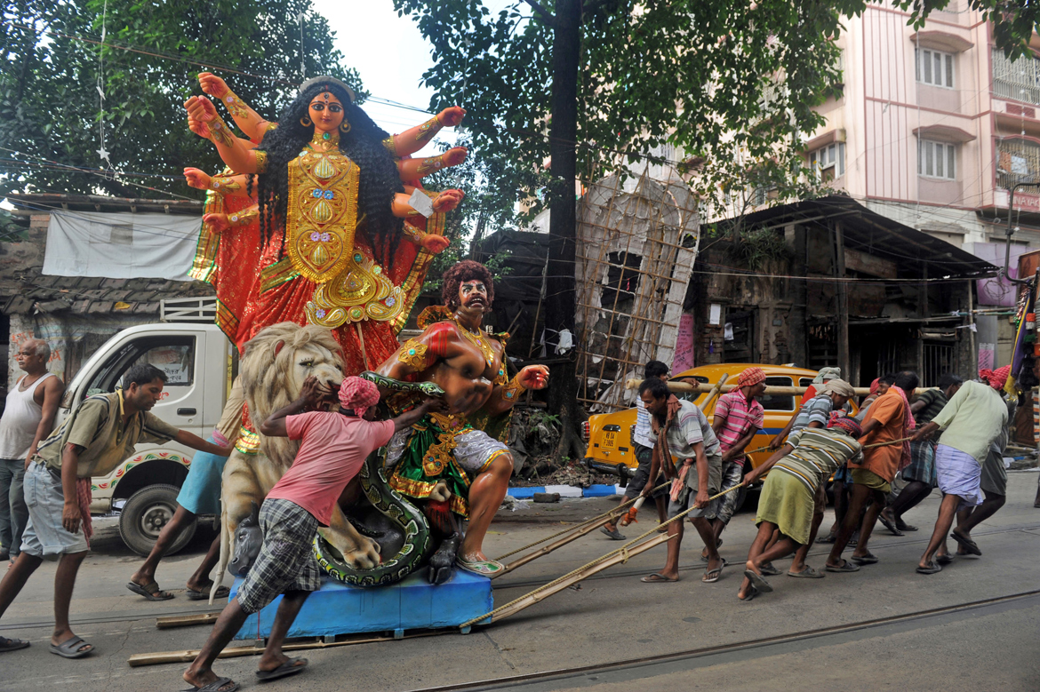 Maa is transported from Kumartuli to her home for the Pujos