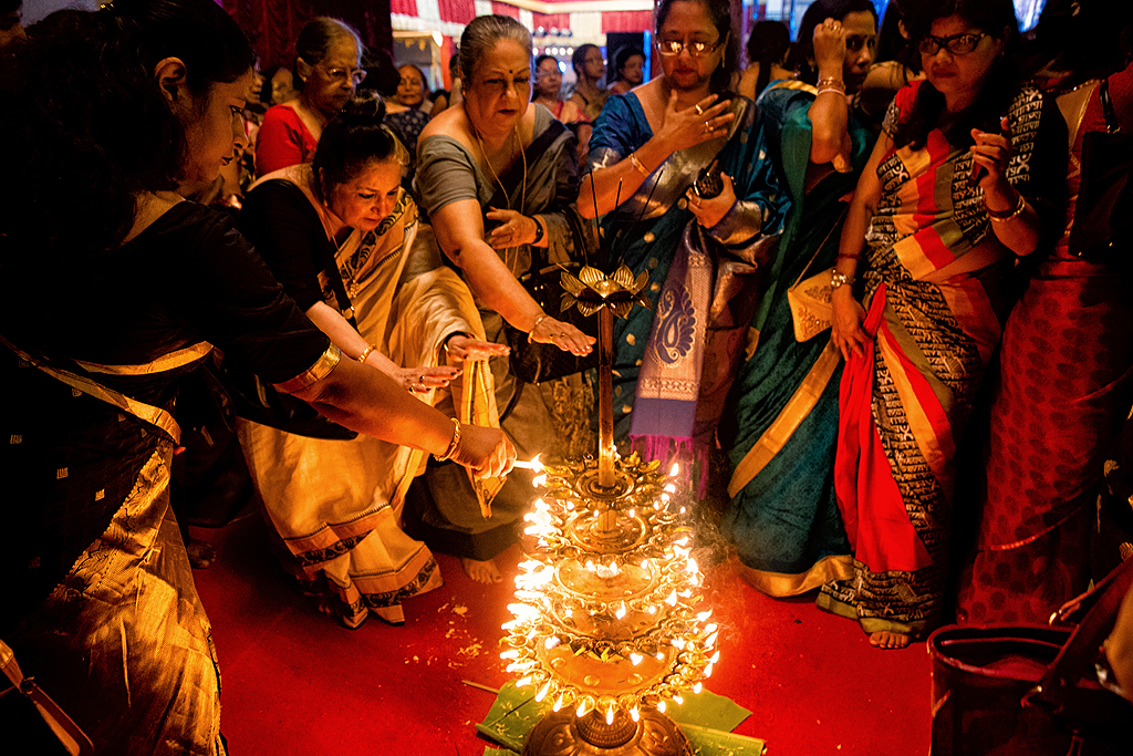 108 lotus flowers are required and lamps are lit for this special Sandhi pujo