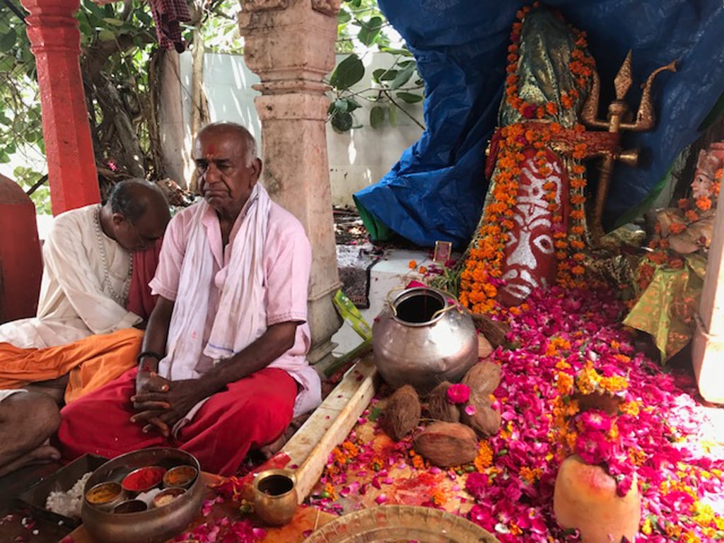 The miraculous Siddhvat tree planted by Parvati was cut down during the Muslim invasion of Ujjain and covered with iron planks, but the tree, seen in the background shot forth piercing through the metal