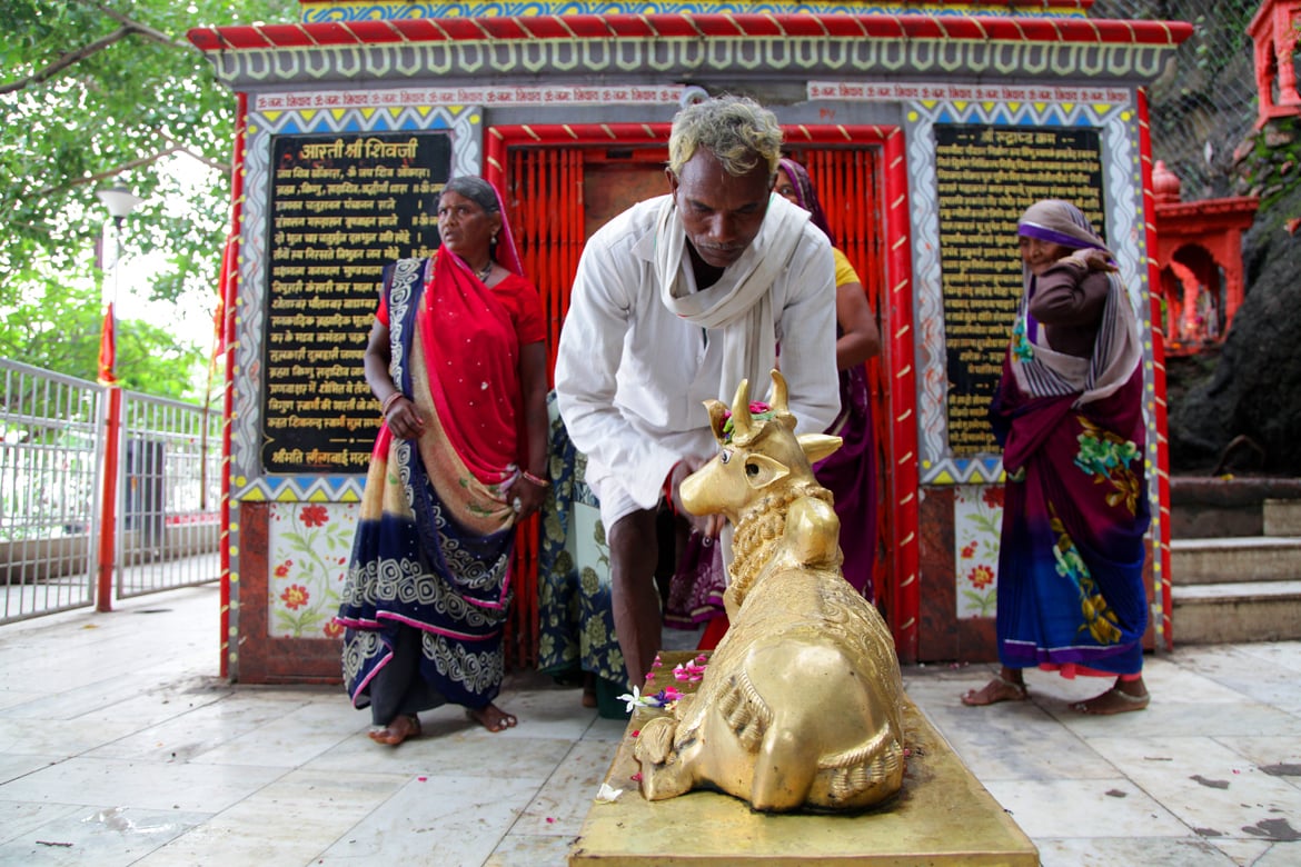 Pilgrims offer their respect to Nandi at a small Shiva shrine near Ma Chamunda temple in Dewas