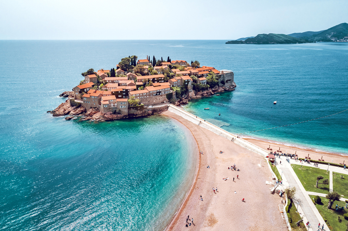 A drone view of the beach of Sveti Stefan in Montenegro by the Adriatic Sea