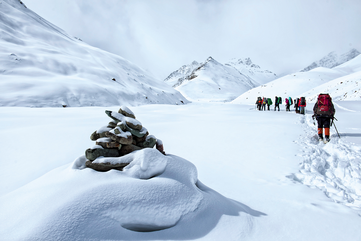 A lone cairn manages to raise its head above the deluge of snow as we make our way towards the summit camp. But for the curtain of clouds, we would have had Stok Kangri for company.