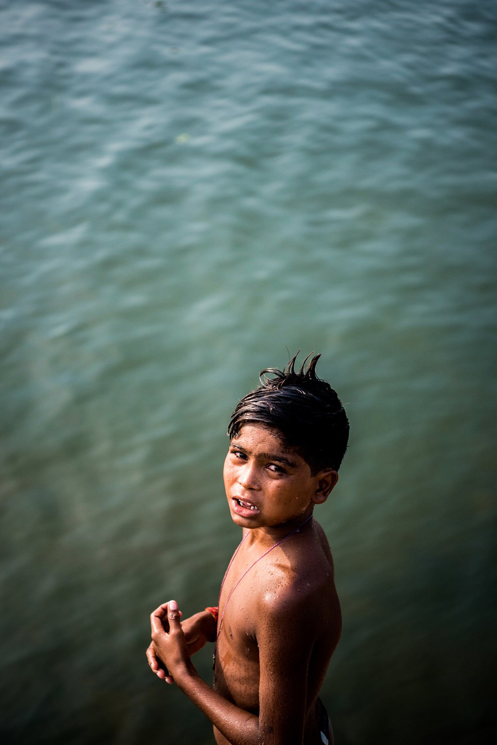 A local boy makes some pocket money by asking visitors to throw a coin into the water, which he dives in and fishes out.