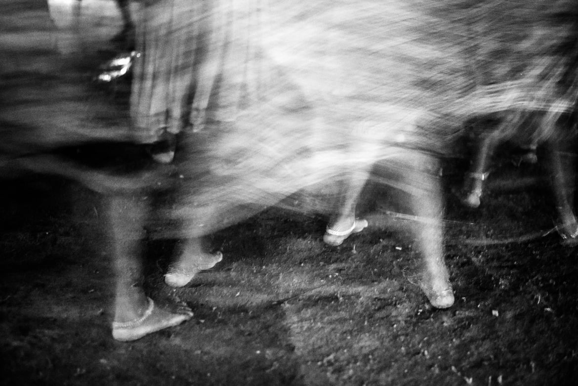 A group of Baiga women perform in a circle. Their metallic anklets add to the rhythm of their songs