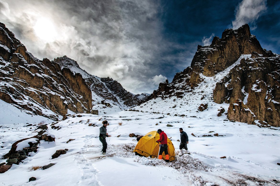 Two Tashis (left and right) and a Mingma (centre) hurry through the ropes of pitching the tent as a churn of clouds threatens to blot out the sun. It was nearly impossible to believe that this was Stok valley’s Changma, a place where people scurry to seek shade under the willow trees in summer.