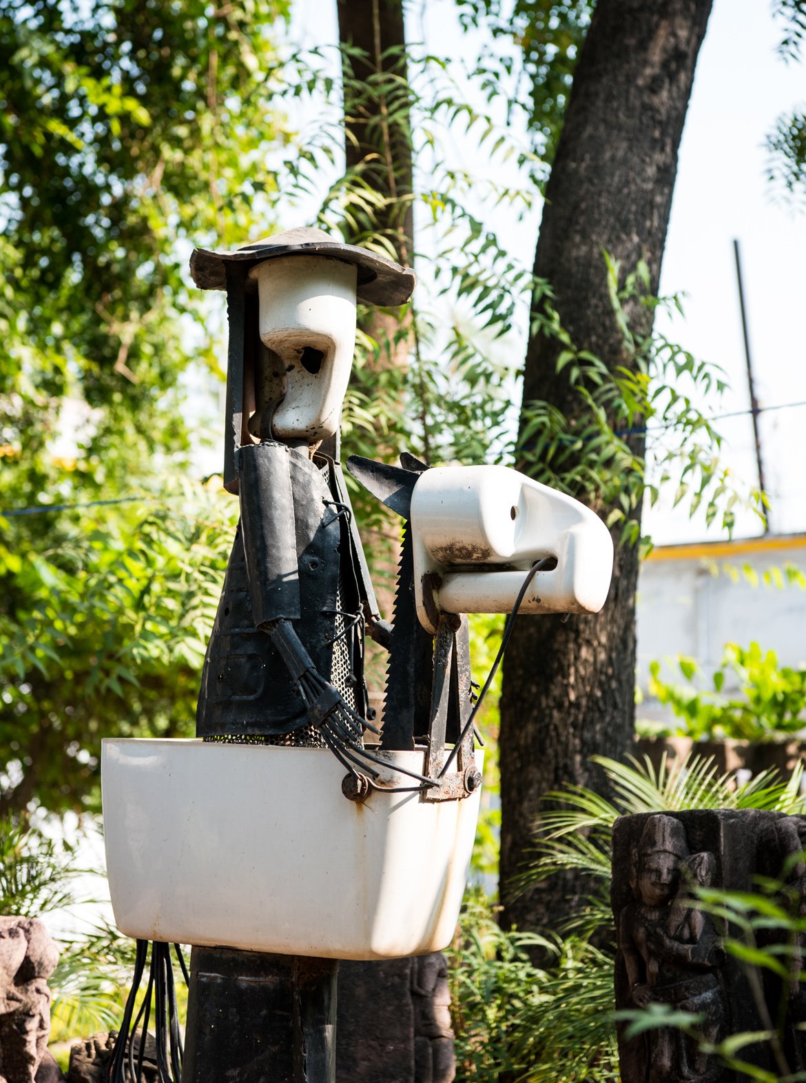 A sculpture made of iron waste and toilet seat at Maihar Heritage Home