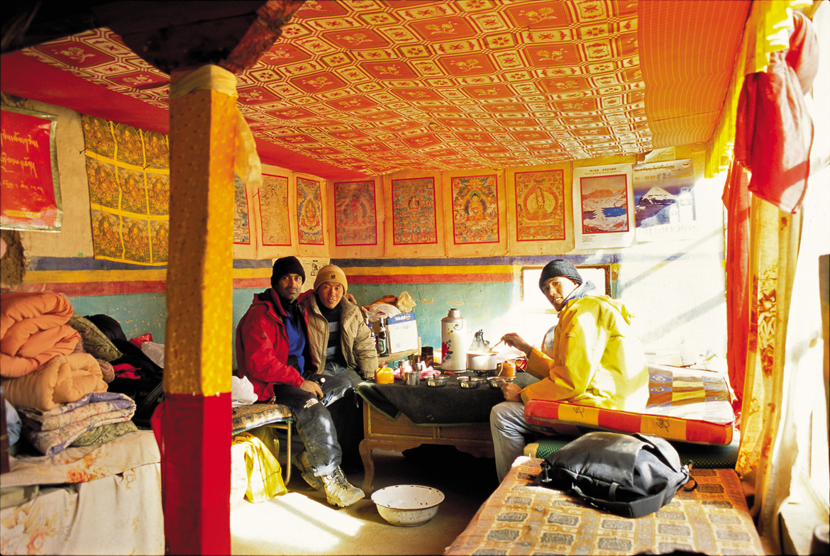 We were grateful to the monks at Gossul Gompa for allowing us to shelter at the monastery for two nights. This, the room they provided us, was a luxury compared to spending a night mummified in a sleeping bag. Here Bhim, my companion from Kathmandu, cooks us Wai-Wai noodle on a butane-fuelled mountaineering stove – a royal feast given the circumstances. Beside me (in the red jacket) is Chunda, a Tibetan friend.