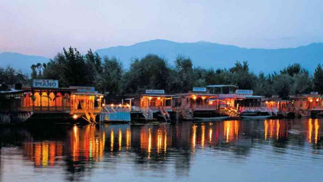 Lights from houseboats cast beautiful reflections on the Dal Lake