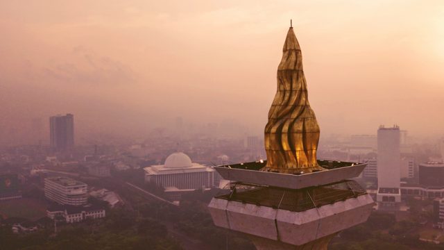 The Flame of Independence at the Monas Tower, which is illuminated in the night.