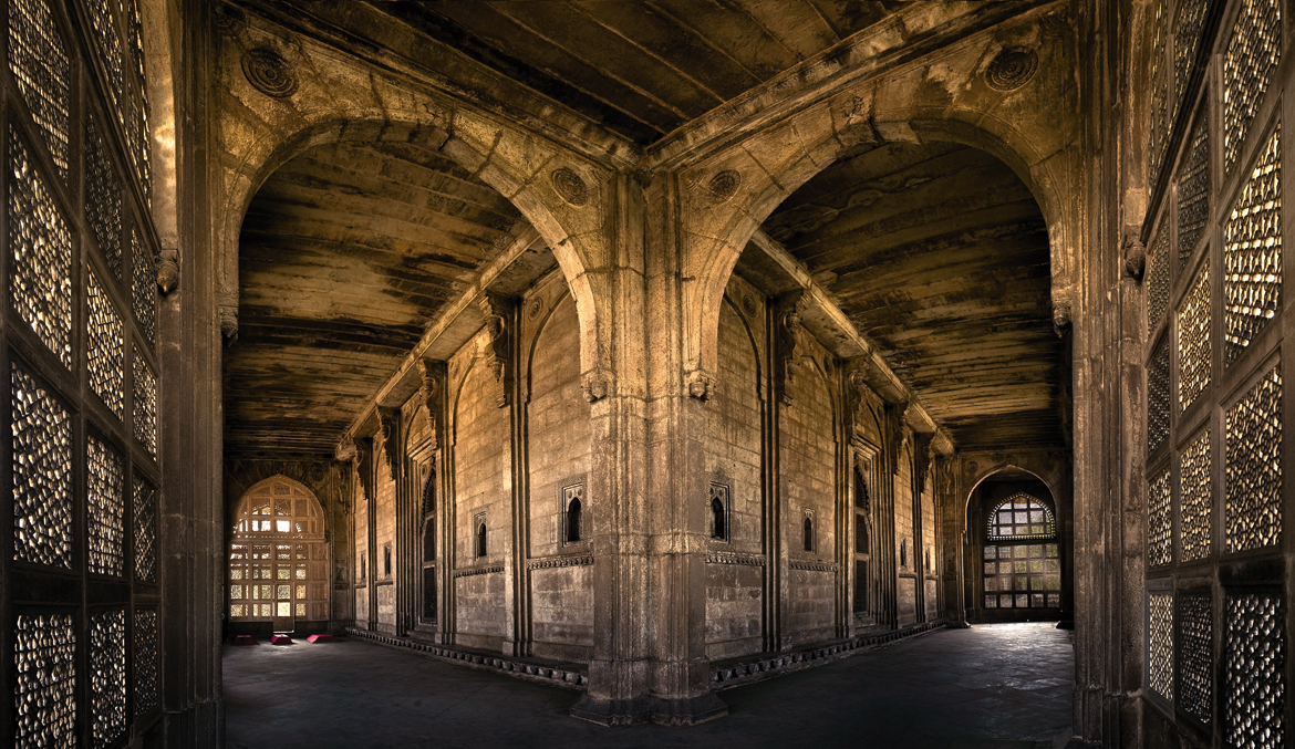 JAMI MASJID, GWALIOR: The Jami Masjid is credited to Mutamad Khan, governor of Gwalior under Alamgir. Its walled compound is entered through a gate crowned with an open bangla pavilion. The prayer hall, of only three domed bays, has a prominent central arched portal flanked by a pair of massive, cylindrical corner towers topped by chhatris. The narrow court in the front is entered from the east through a pishtaq-type portal, also topped by an open bangla pavilion